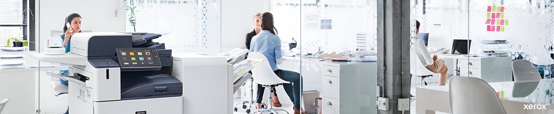 A spacious office featuring a Xerox® printer and a computer on a desk, showcasing a professional work environment. A spacious office featuring a Xerox® printer and a computer on a desk, showcasing a professional work environment.
