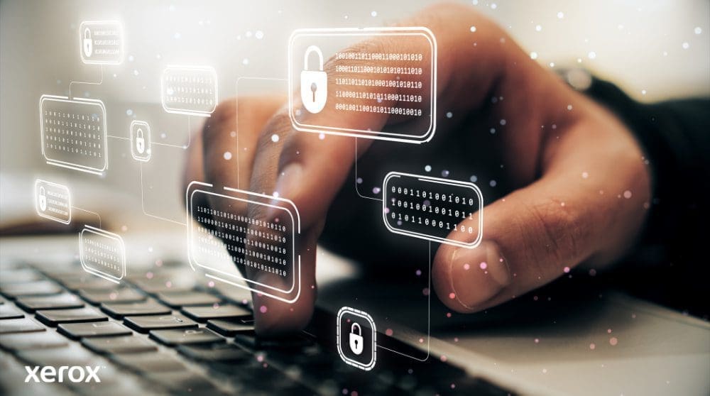 Xerox® ConnectKey®: Advanced Security Features A person's hand is typing on a laptop keyboard, with glowing digital lock and binary code icons superimposed over the image, symbolizing robust cyber security and data protection.